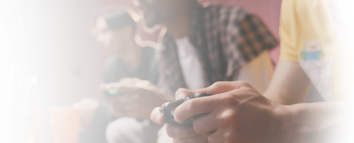 Human hand holding a gamepad during videogame session