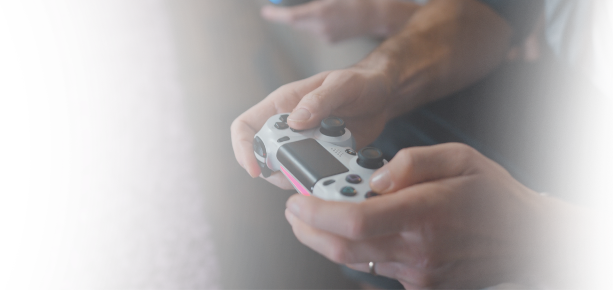 Human hand holding a gamepad during videogame session